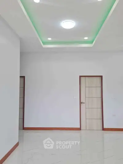 Spacious modern interior with sleek ceiling lights and elegant doors.