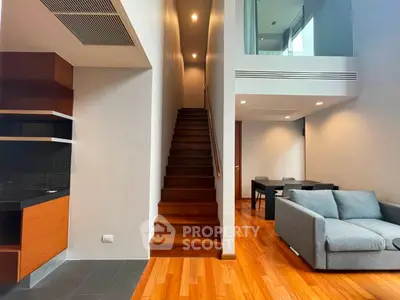 Modern duplex living room with wooden staircase and stylish furniture