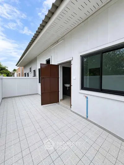 Spacious outdoor terrace with tiled flooring and modern exterior design