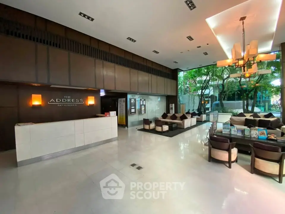 Luxurious lobby with modern seating and elegant lighting at The Address Pat Muang.