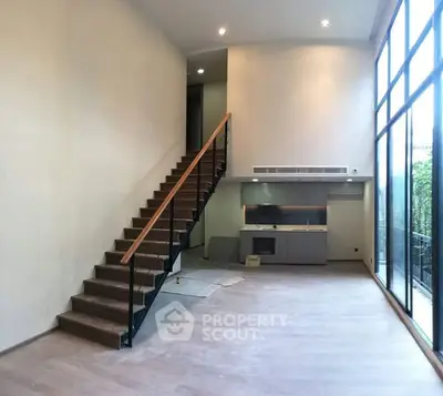 Spacious modern living room with high ceilings and large windows