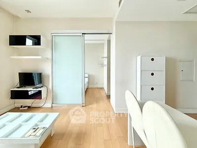 Modern minimalist living room with sliding glass door and sleek furniture