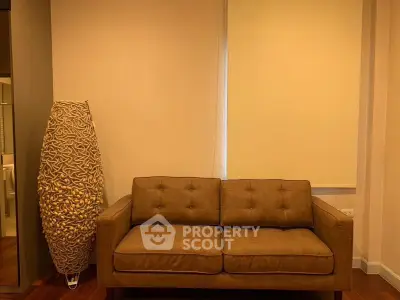 Cozy living room with stylish brown sofa and unique floor lamp