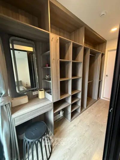 Spacious walk-in closet with modern shelving and vanity in luxury apartment