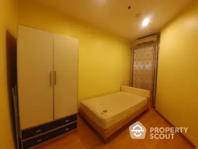 Cozy bedroom with ample storage featuring a large wardrobe and under-bed drawers, warm lighting, and a serene ambiance perfect for restful nights.