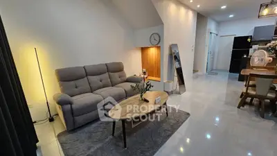 Modern living room with stylish furniture and open kitchen layout