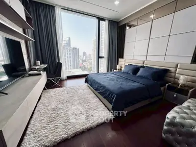 Luxurious bedroom with city view, modern decor, and plush furnishings in high-rise apartment.