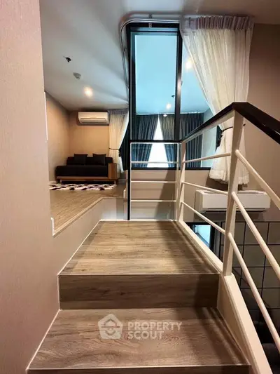 Modern duplex apartment with stylish staircase and cozy living area