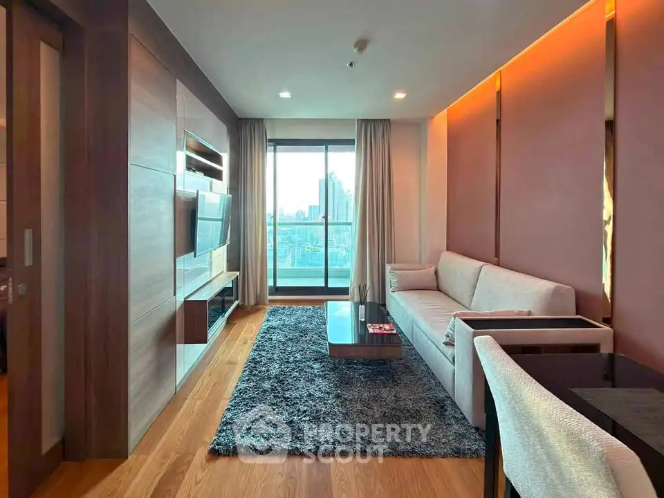 Modern living room with city view, featuring sleek furniture and warm lighting.