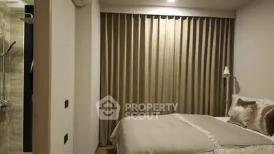 Cozy bedroom with elegant curtains and modern shower area