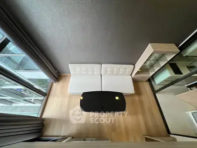 Modern living room with stylish furniture and large windows offering natural light.