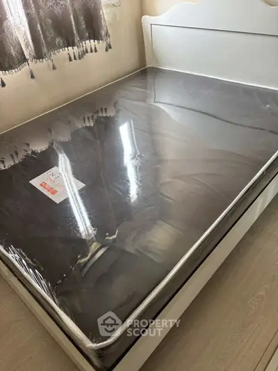 Spacious bedroom with new mattress and elegant curtains, perfect for comfort and relaxation.