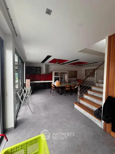 Spacious modern living room with open layout and stylish staircase