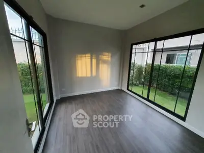Spacious room with large windows and garden view, perfect for natural light lovers.