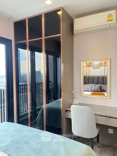 Modern bedroom with city view, stylish wardrobe, and cozy workspace