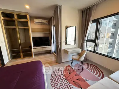 Modern bedroom with stylish decor, large windows, and built-in wardrobe in a high-rise apartment.