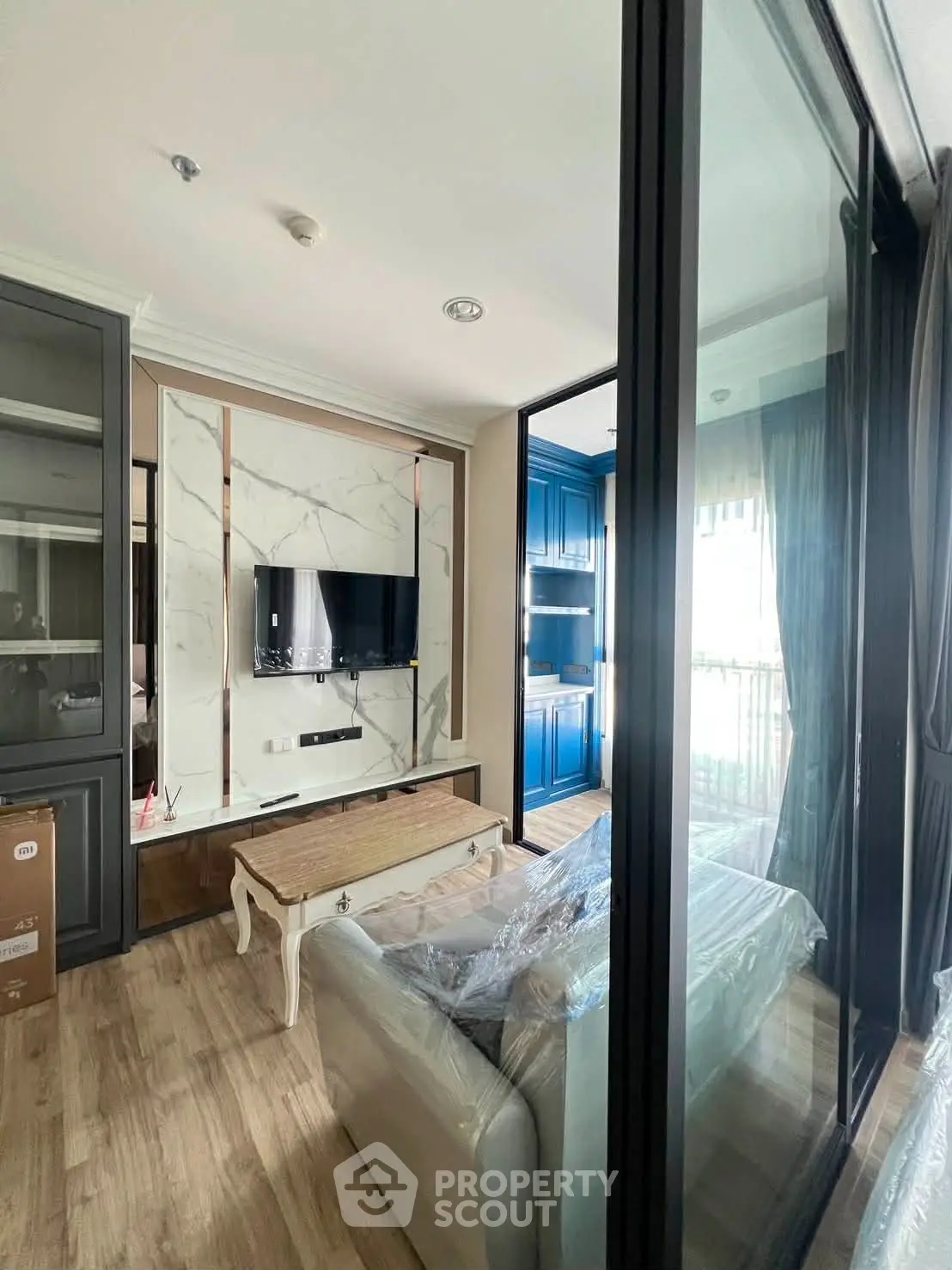 Modern living room with stylish decor and large windows offering natural light.