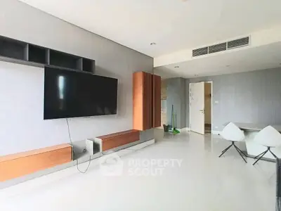 Modern living room with wall-mounted TV and minimalist furniture