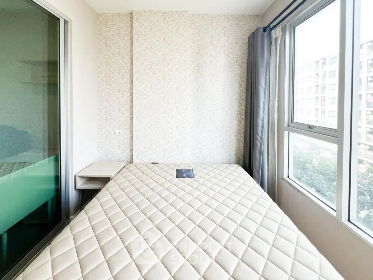 Bright bedroom with large windows and modern decor