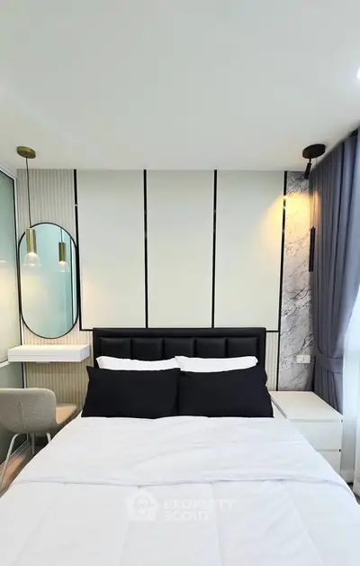 Modern bedroom with stylish decor, featuring a cozy bed, elegant lighting, and a chic vanity area.