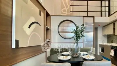 Modern dining area with stylish decor and open kitchen layout in a contemporary apartment.