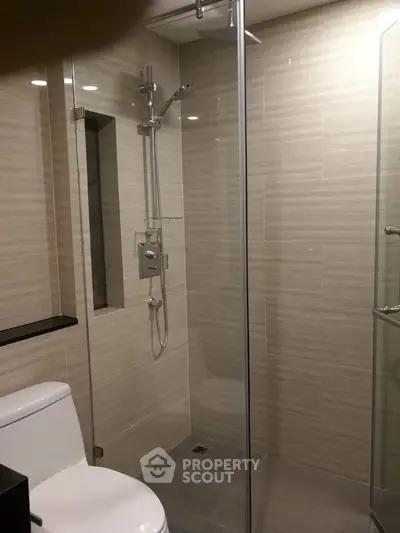 Modern bathroom with glass shower and sleek tile design