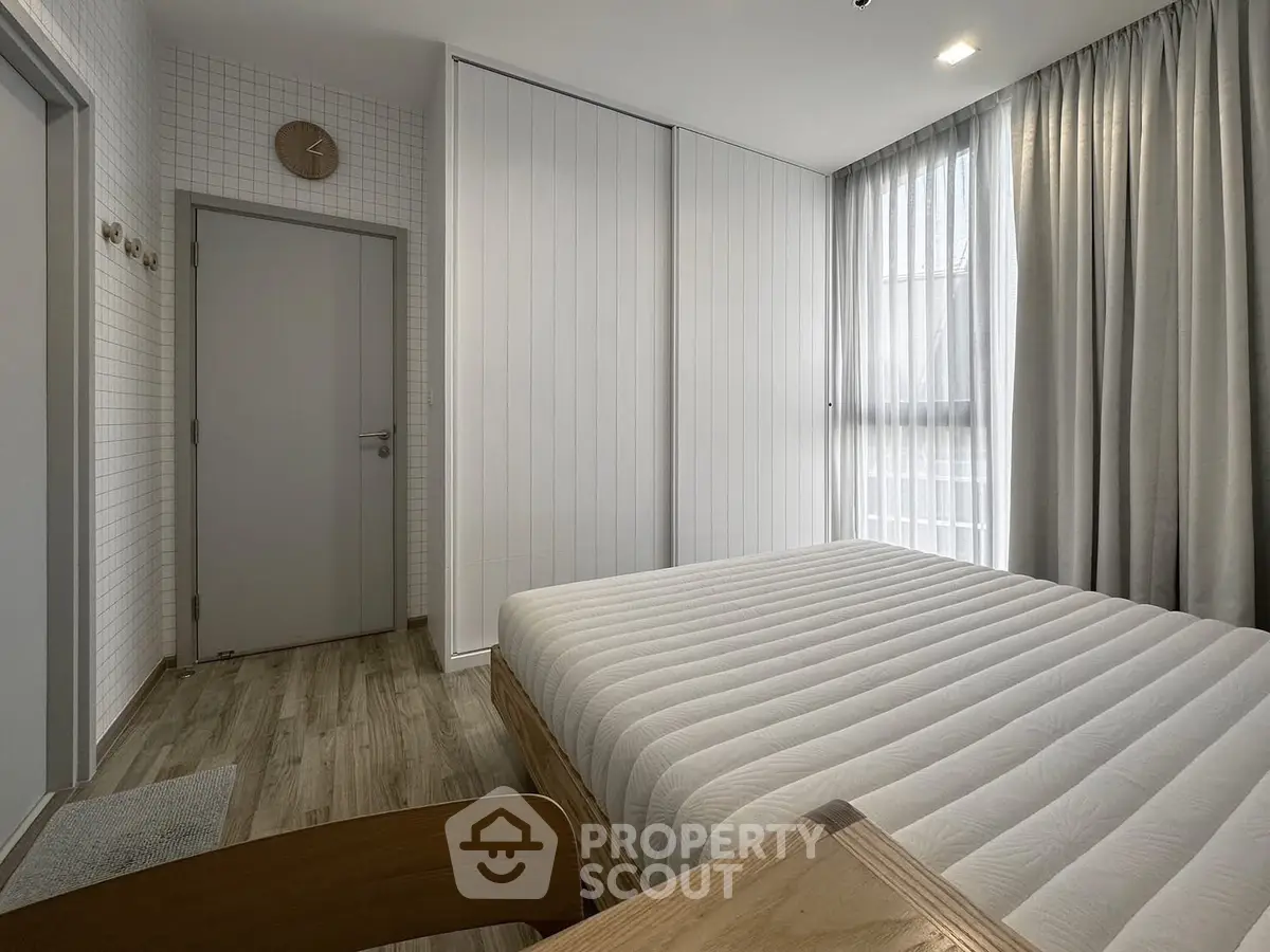 Modern minimalist bedroom with natural light and stylish decor