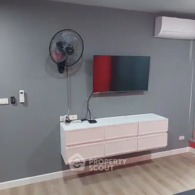 Modern living room with wall-mounted TV and air conditioning unit