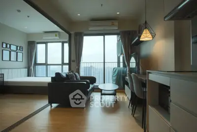 Modern open-plan living room with balcony view in high-rise apartment