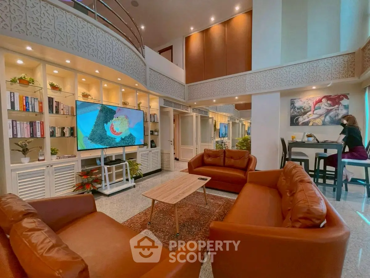 Spacious living room with high ceilings, elegant decor, and cozy seating area.