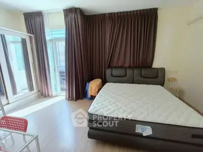 Spacious bedroom with large windows and modern decor