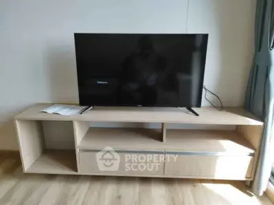 Modern living room with sleek TV stand and flat-screen television, perfect for entertainment setup.