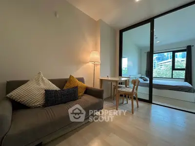 Modern studio apartment with cozy living area and bedroom, featuring stylish decor and natural light.
