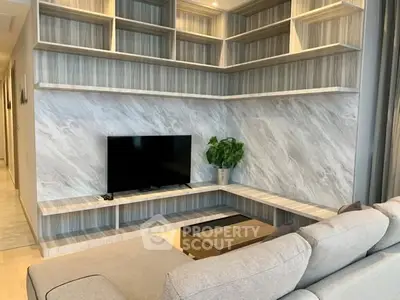 Modern living room with stylish shelving and cozy sofa, perfect for relaxation and entertainment.