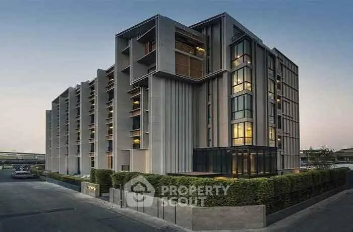 Modern architectural building with sleek design and large windows, showcasing urban living.