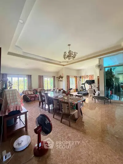 Spacious living room with elegant dining area and large windows for natural light.
