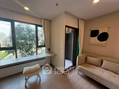 Bright living room with large windows and cozy seating area