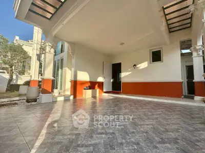 Spacious covered patio with elegant tile flooring and modern design, perfect for outdoor relaxation.
