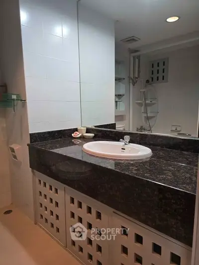 Modern bathroom with sleek vanity and large mirror