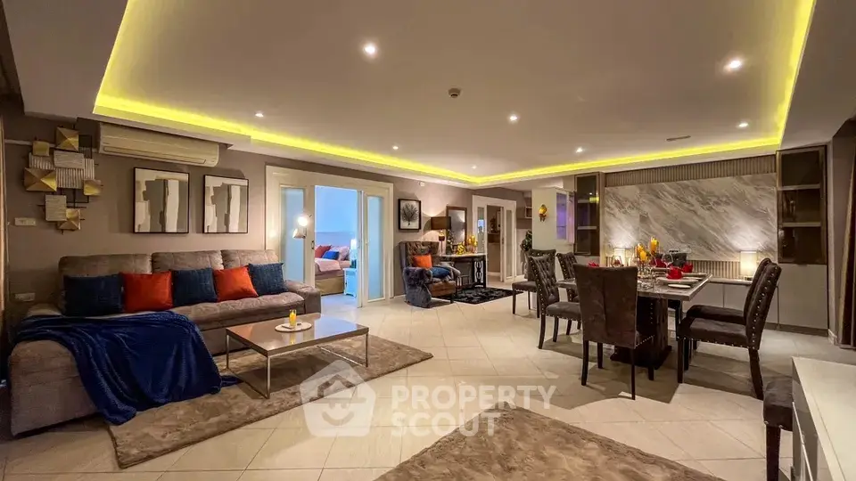 Luxurious open-plan living and dining area with modern decor and ambient lighting.