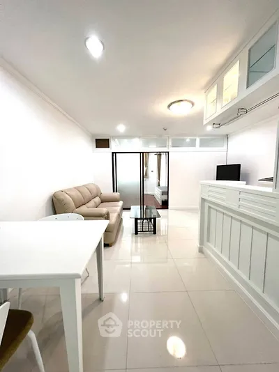Modern open-plan living room with sleek furniture and bright lighting