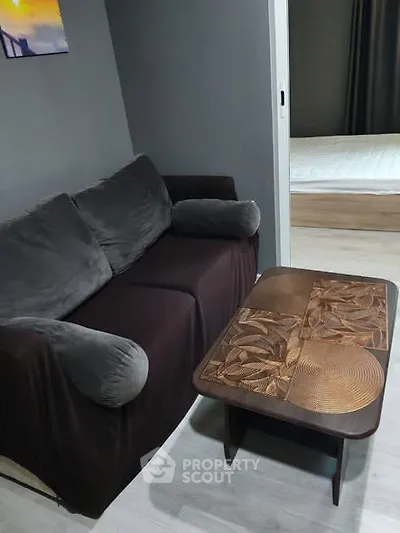 Cozy living room with stylish sofa and artistic coffee table in modern apartment.