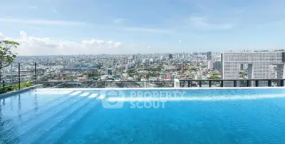 Stunning rooftop pool with panoramic city skyline view, perfect for luxury urban living.