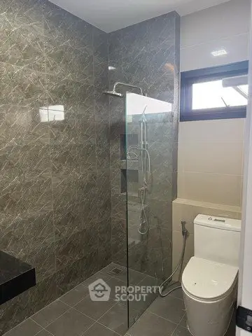 Modern bathroom with glass shower and sleek tile design