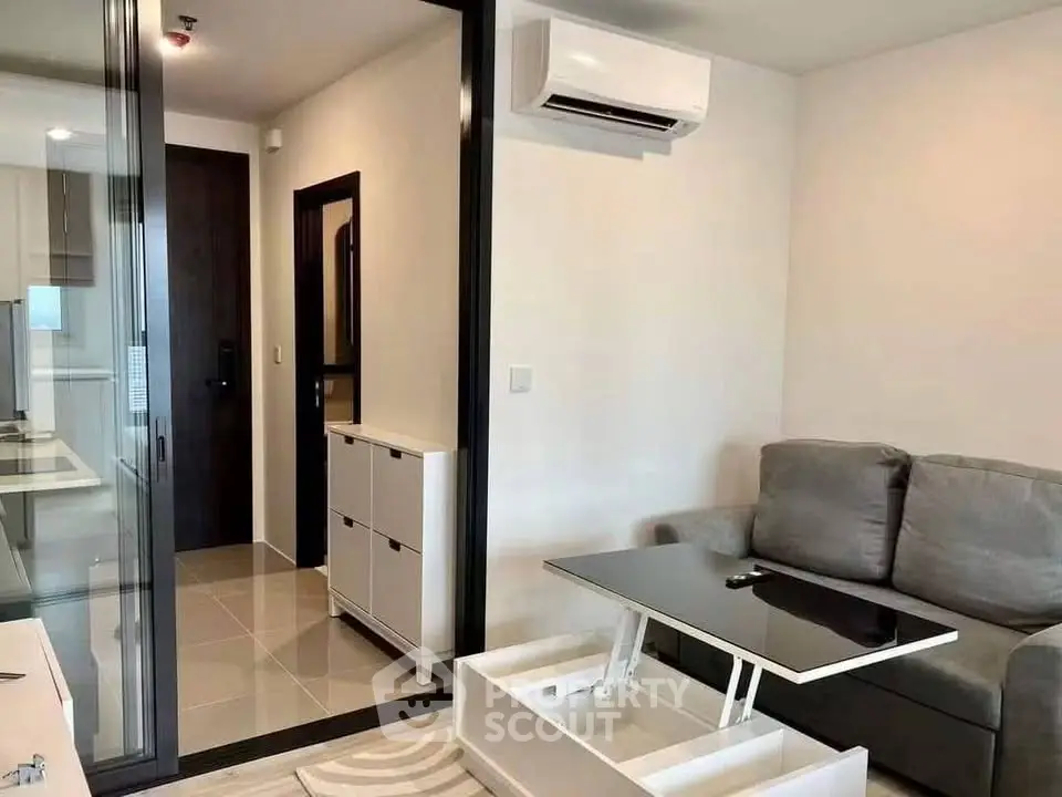 Modern living room with sleek furniture and air conditioning in a stylish apartment.