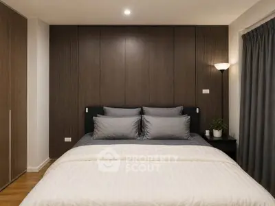 Modern bedroom with elegant wood paneling and cozy lighting