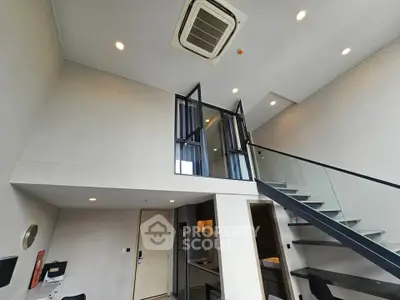 Modern loft apartment with high ceilings and sleek staircase