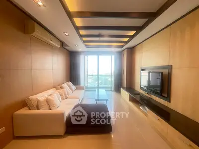 Spacious modern living room with elegant design and large windows offering natural light and city views.