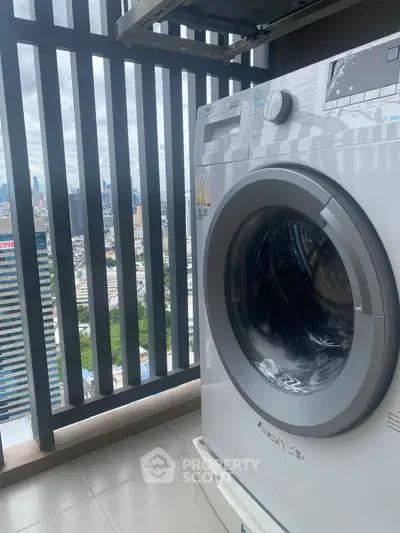 High-rise balcony with washing machine and city skyline view