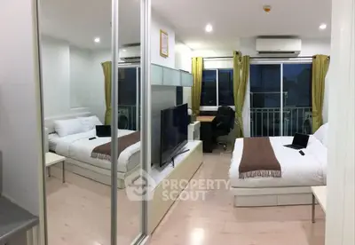 Modern bedroom with mirrored closet, twin beds, and balcony view in stylish apartment.